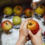 washing-apples-in-sink-royalty-free-image-717166647-1533832681